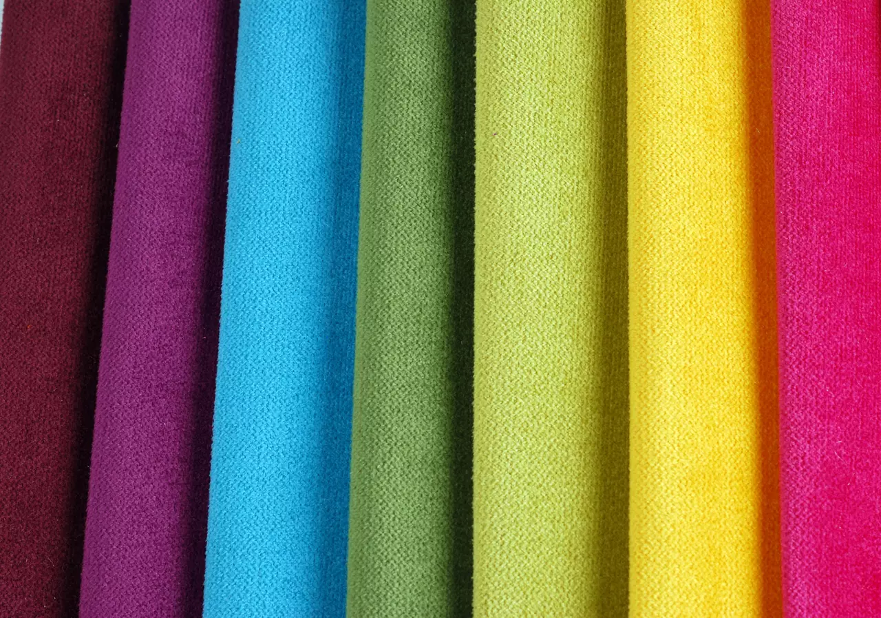 Bright collection of colorful velour textile samples. Fabric texture background