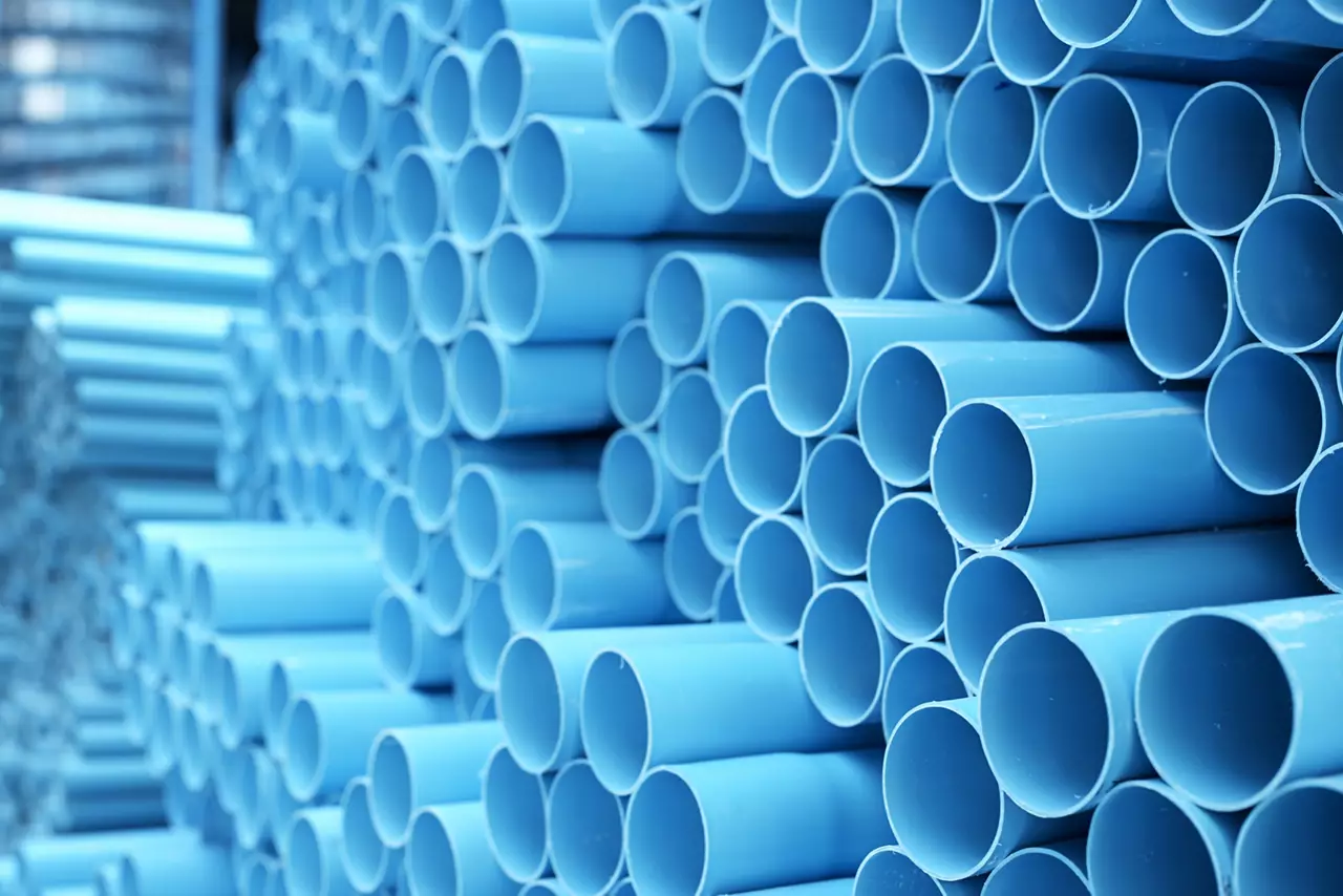 background of colorful  Blue PVC pipes stacked in construction site
