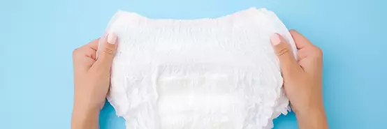 Baby diaper on blue background 