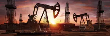 Oil pumps and drills during sunset