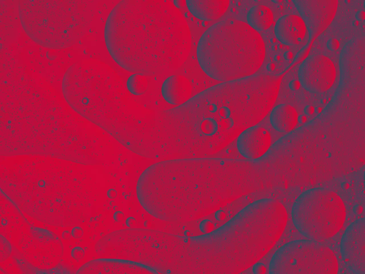 Full frame of the textures formed by the bubbles and drops of oil in the shape of circle floating on a gray and yellow colors background - red texture