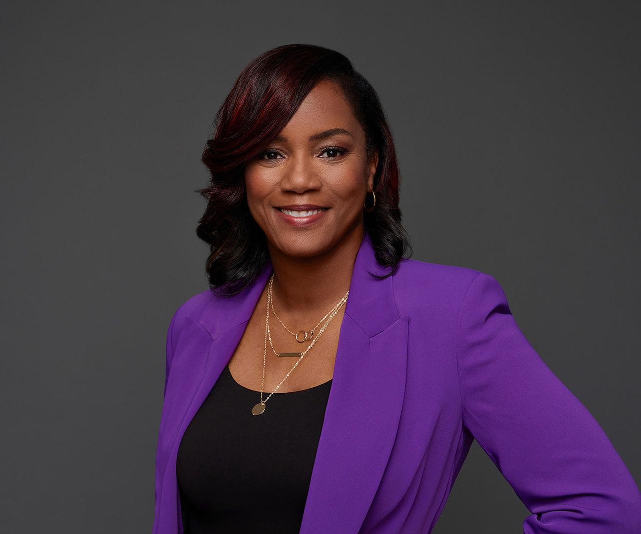 Alveda Williams wearing a purple jacket