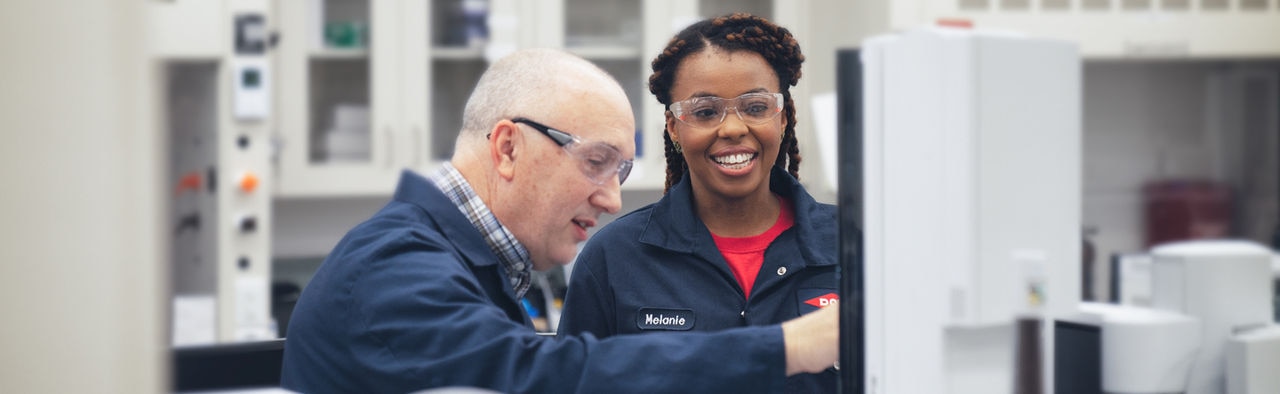 Melanie Robinson in the lab with a colleague