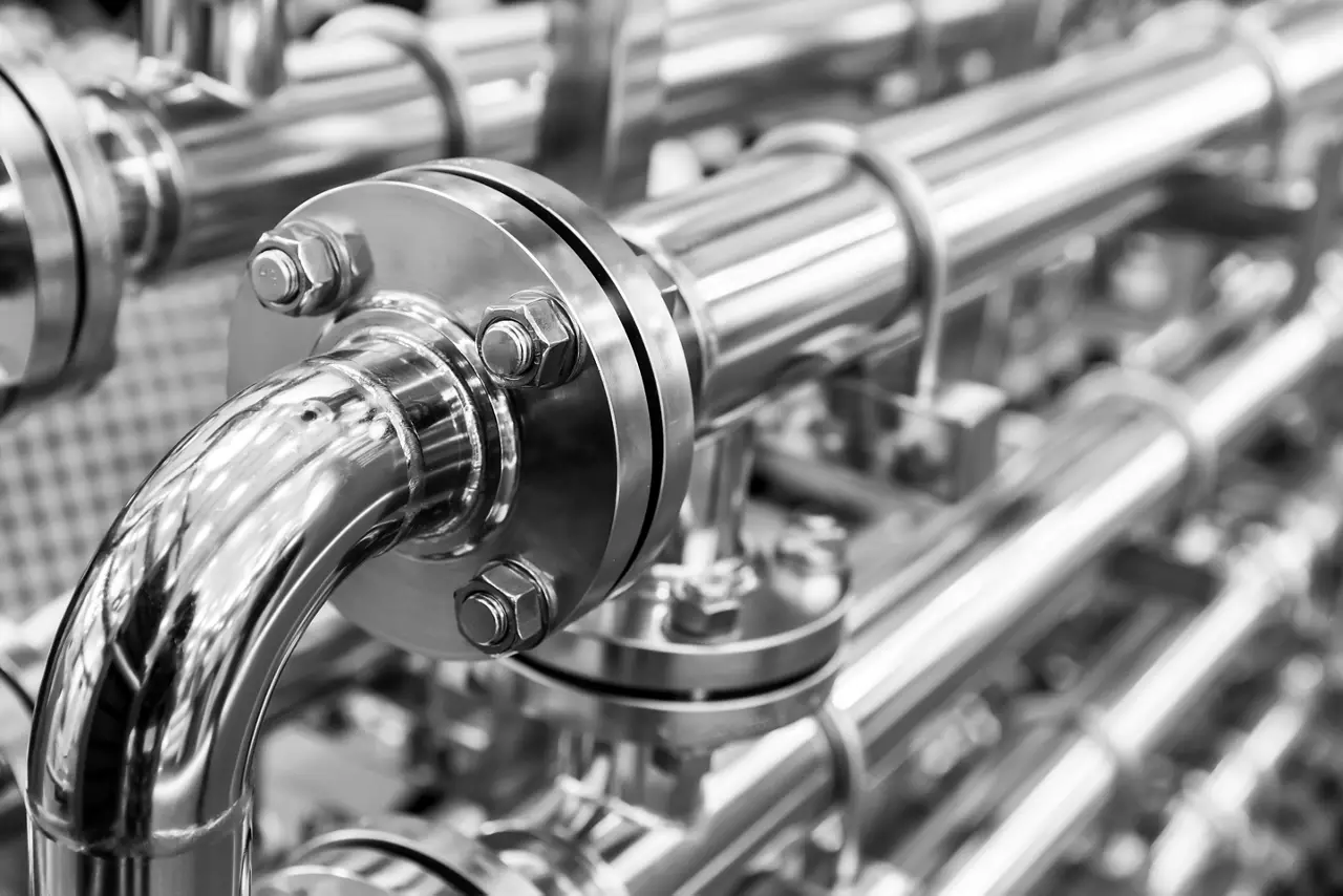 Person cleaning manufacturing equipment