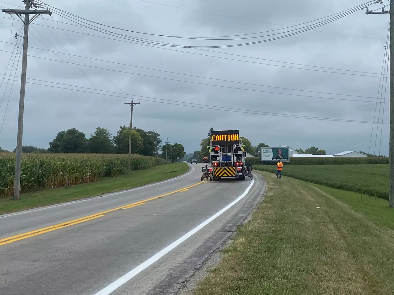 Pavement marking vehicle applying paint to highway