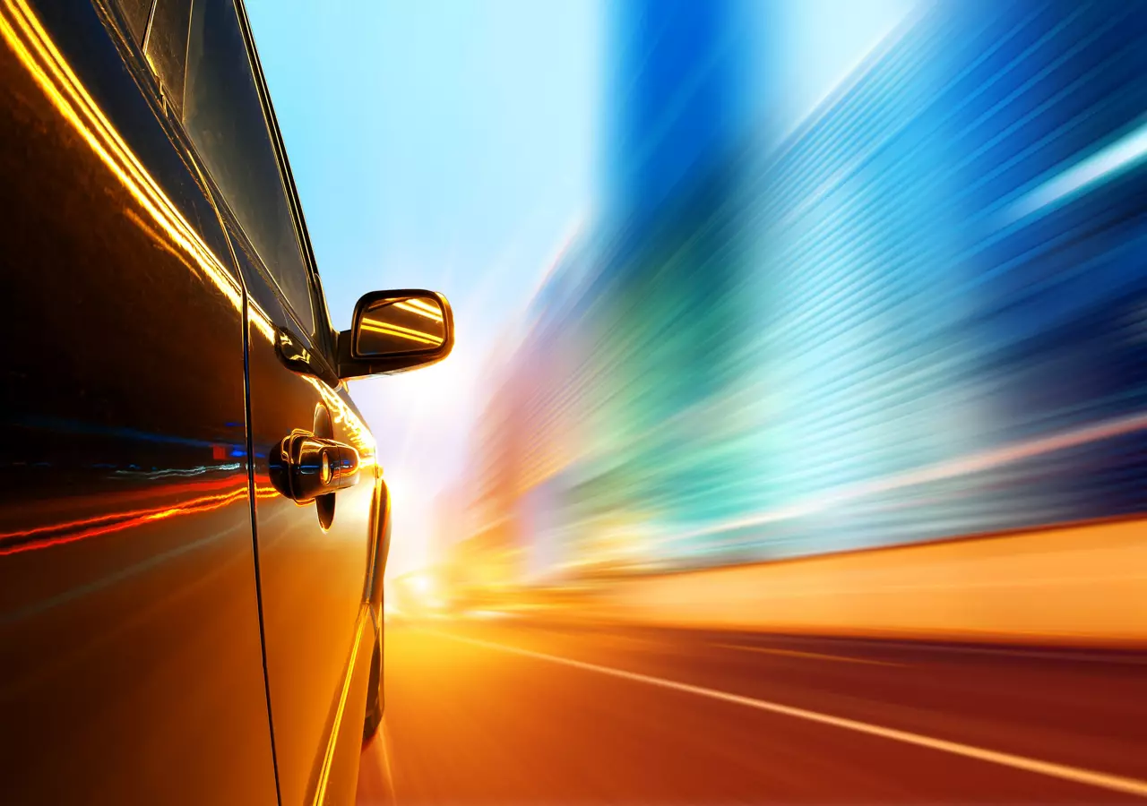 Side of the car driving on a motorway at high speeds